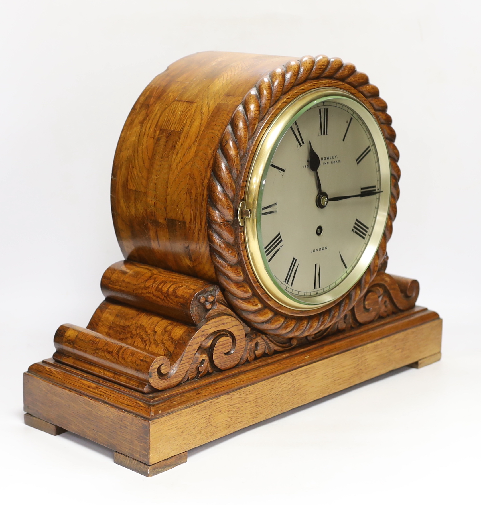 An Edwardian laminated oak single fusee mantel timepiece, A&H Rowley, 35cm high